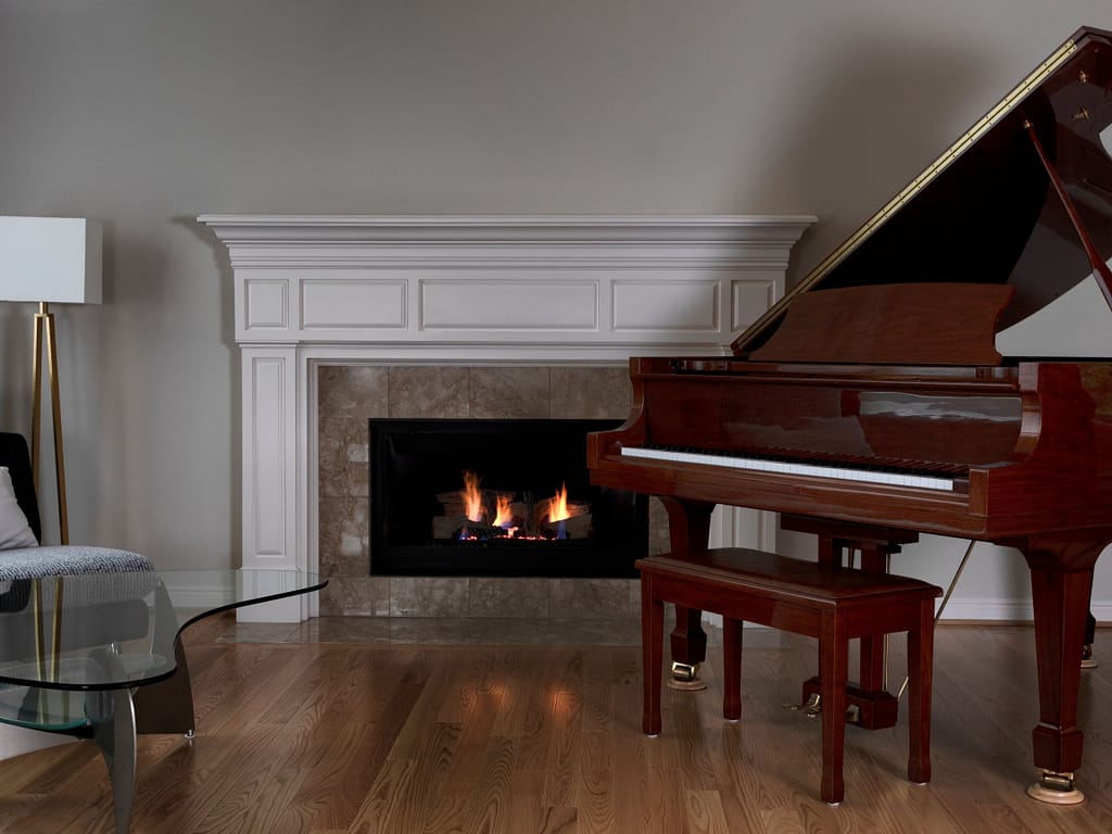 piano-and-fireplace-in-a-room-with-wood-floor