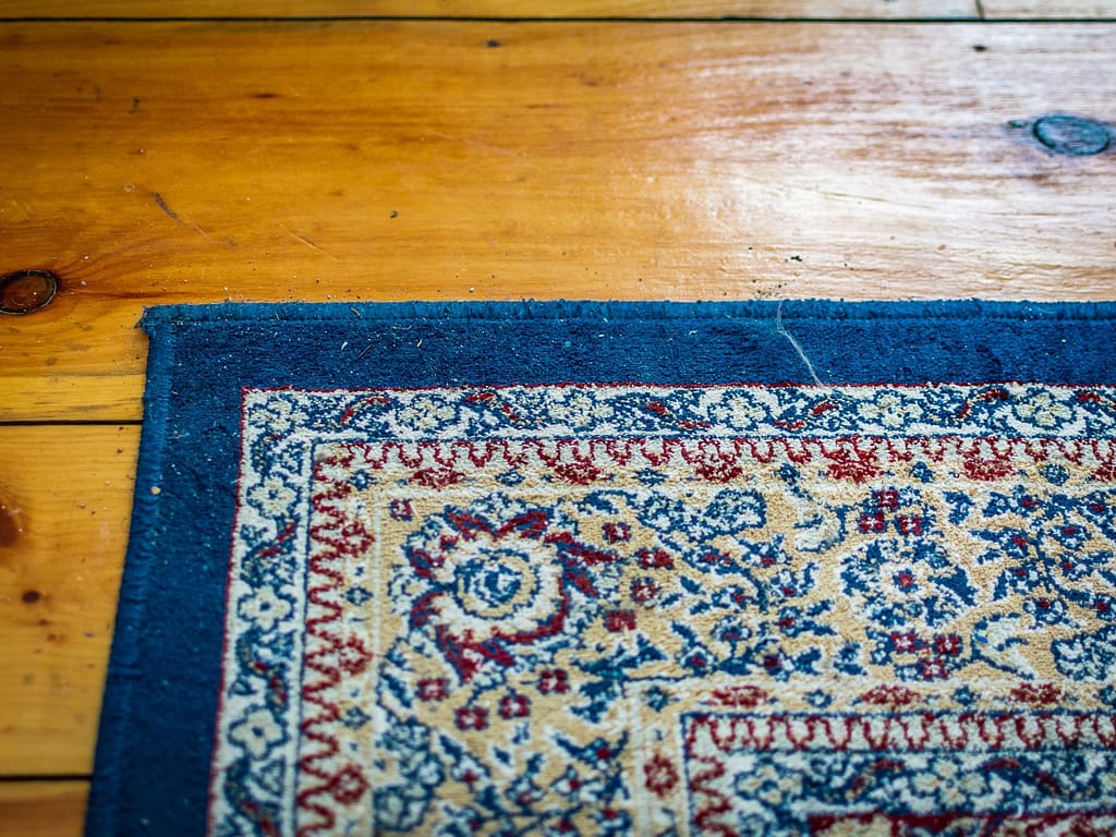 pine floor with a carpet on top